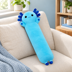 Blue axolotl plush pillow resting on an ivory sofa.